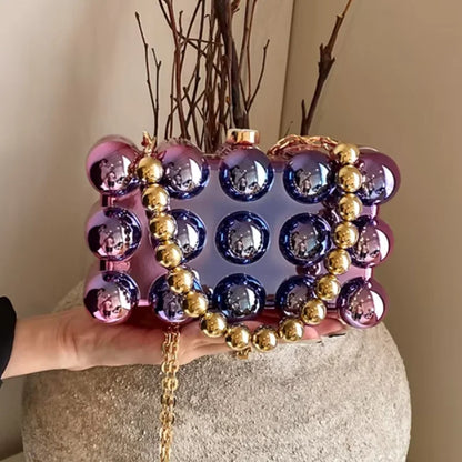 Iridescent orb clutch with gold bead chain